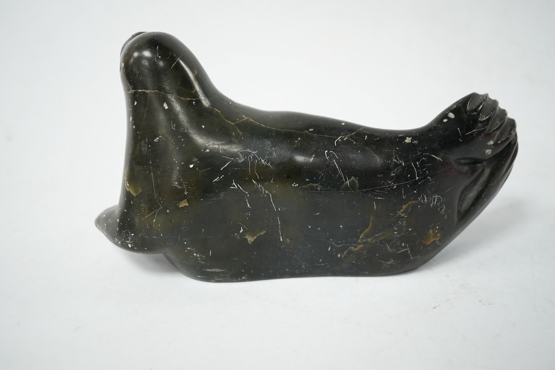 An Inuit soapstone carved seal sculpture, incised date 1980 to the base. Condition - fair